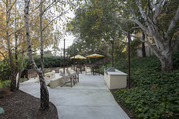 Outdoor grill area with seating at Pacific Vista Apartments, offering residents a space for outdoor cooking and socializing