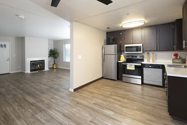 Cozy kitchen with modern appliances and granite countertops at Waterscape Apartments
