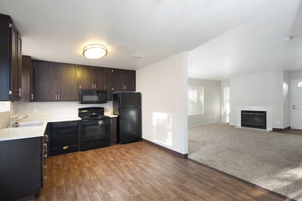 Modern kitchen with stainless steel appliances in Waterscape Apartments