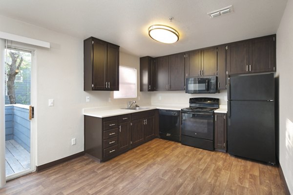 Modern kitchen with stainless steel appliances at Waterscape Apartments