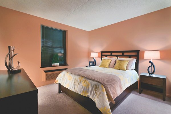 Modern bedroom with large windows at Chancery Square Apartments, offering luxury living spaces in a prime location