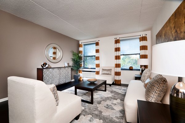 Elegant living room with contemporary decor and natural light at Chancery Square Apartments