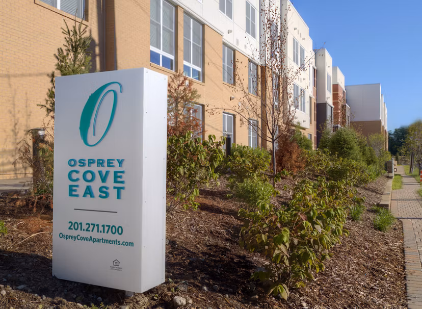 Osprey Cove Apartments: Scenic view of modern apartments in tranquil community setting