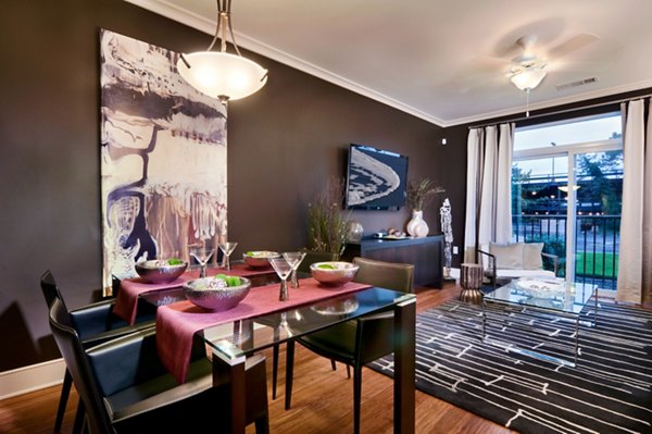 Dining room featuring elegant dining set and large windows at Osprey Cove Apartments, a Greystar luxury community