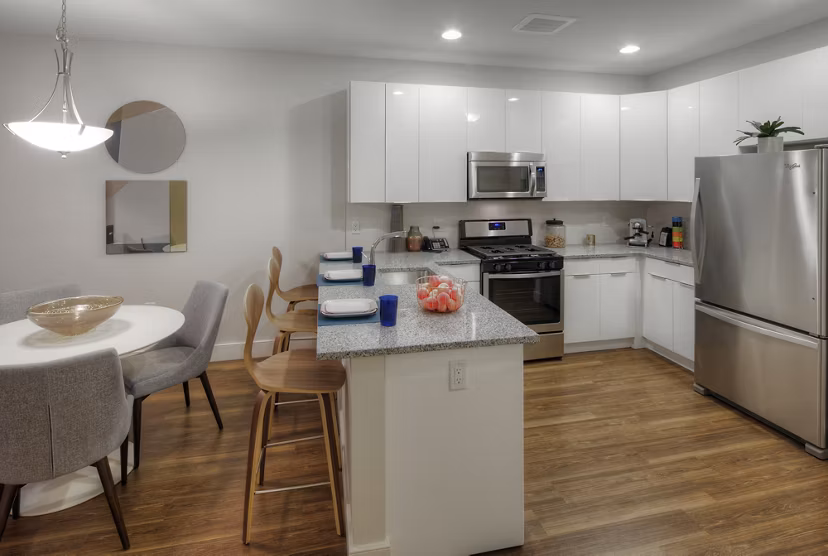 Modern kitchen with stainless steel appliances at Osprey Cove Apartments, offering luxury living spaces
