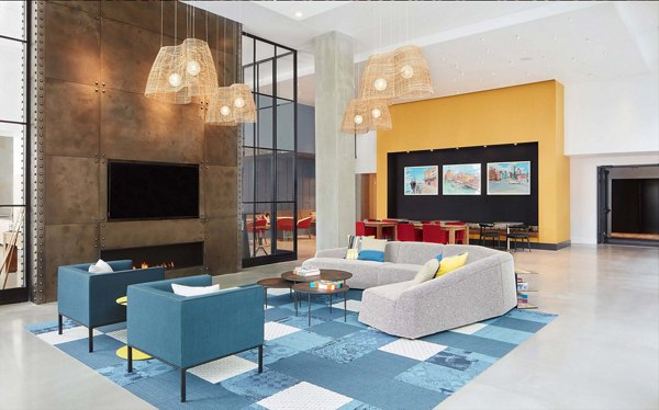 Modern clubhouse featuring a stylish lounge and entertainment area at Watermark Seaport Apartments, perfect for social gatherings and relaxation