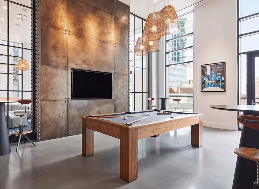Game room with pool table and lounge seating at Watermark Seaport Apartments