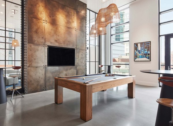 Game room with pool table and lounge seating at Watermark Seaport Apartments