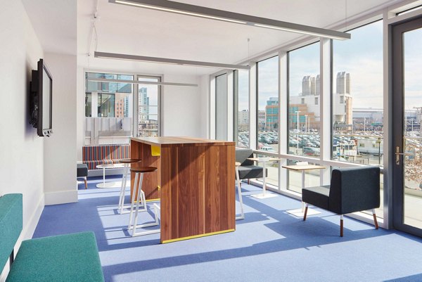 Clubhouse with modern design and ample seating at Watermark Seaport Apartments Ideal for community gatherings and events