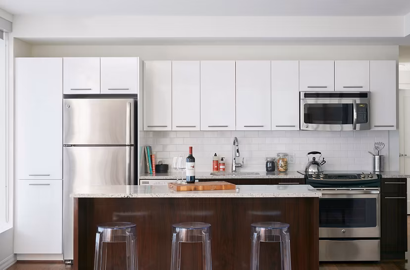 Modern kitchen with stainless steel appliances at Watermark Seaport Apartments