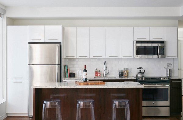 Modern kitchen with stainless steel appliances at Watermark Seaport Apartments