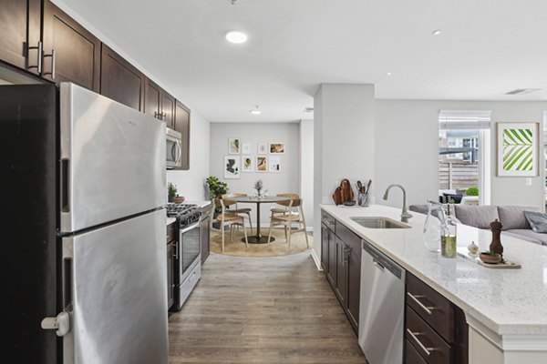 Modern kitchen with granite countertops and stainless steel appliances in Midtown at Camp Springs Apartments