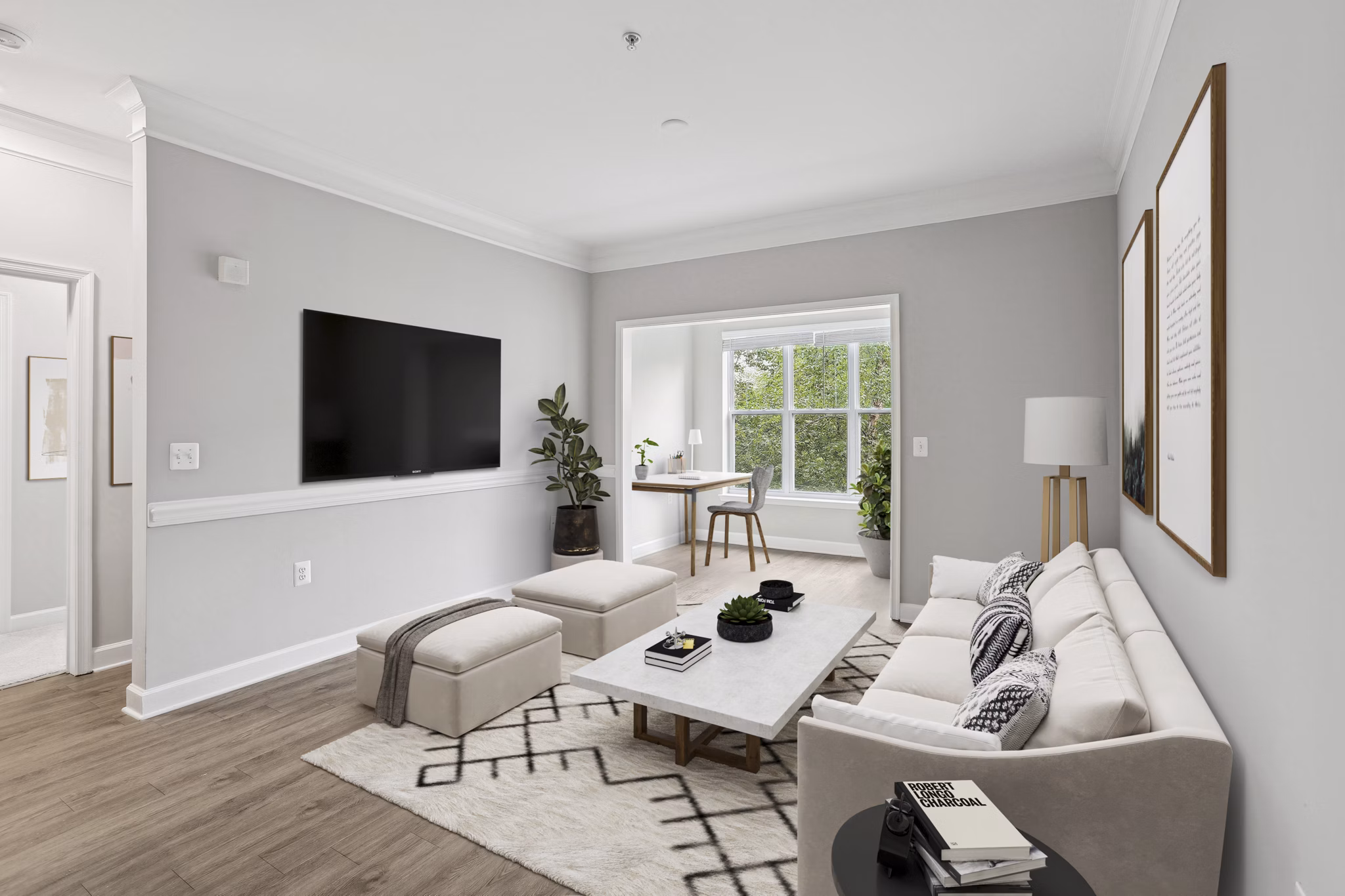 Living room with contemporary furniture and large windows at Midtown at Camp Springs Apartments