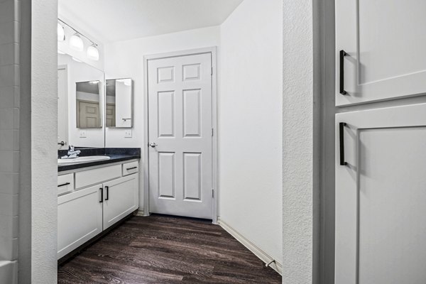 Modern bathroom featuring dual sinks and marble countertops at Envision Apartments