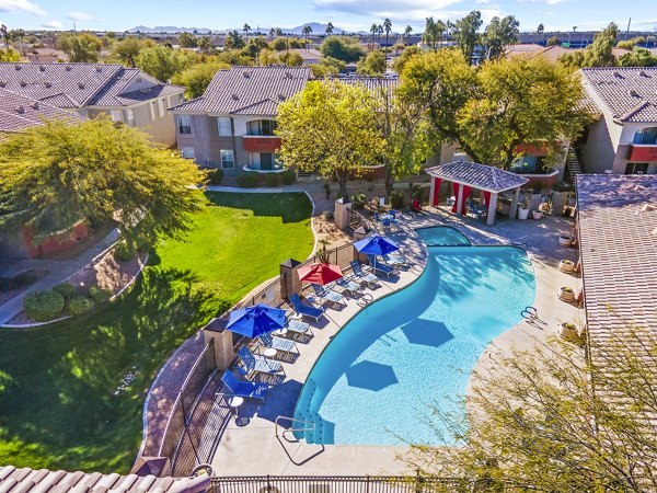 Resort-style pool with lounge chairs at Envision Apartments, luxury living space