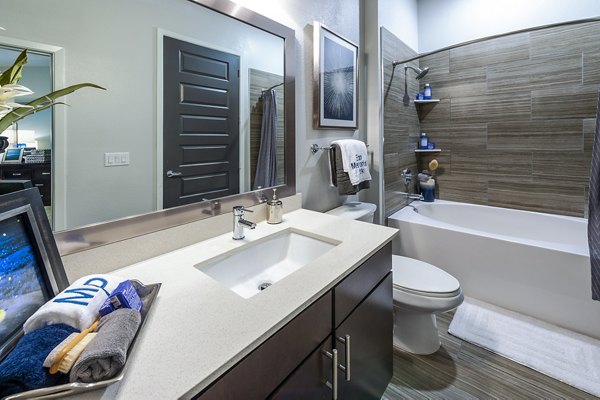 Bathroom with sleek finishes at Elan Memorial Park Apartments, featuring modern fixtures and ample natural lighting for a luxury living experience