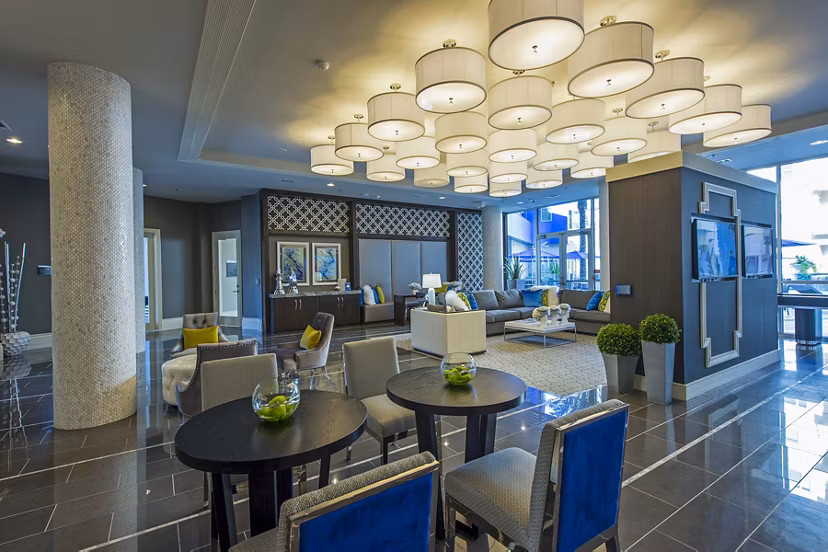 Spacious clubhouse lounge with contemporary decor at Elan Memorial Park Apartments, featuring ample seating and stylish lighting accents