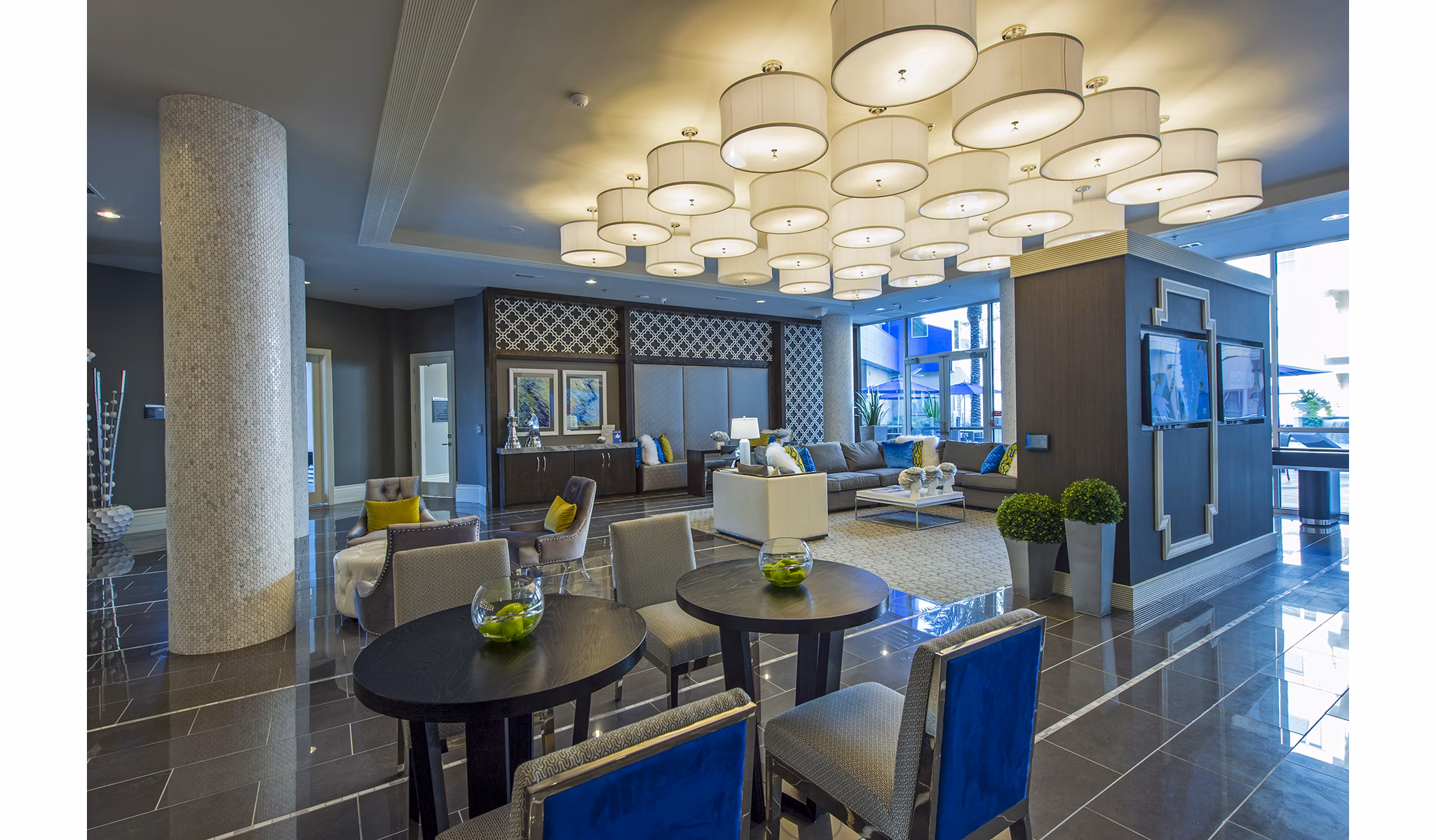 Spacious clubhouse lounge with contemporary decor at Elan Memorial Park Apartments, featuring ample seating and stylish lighting accents