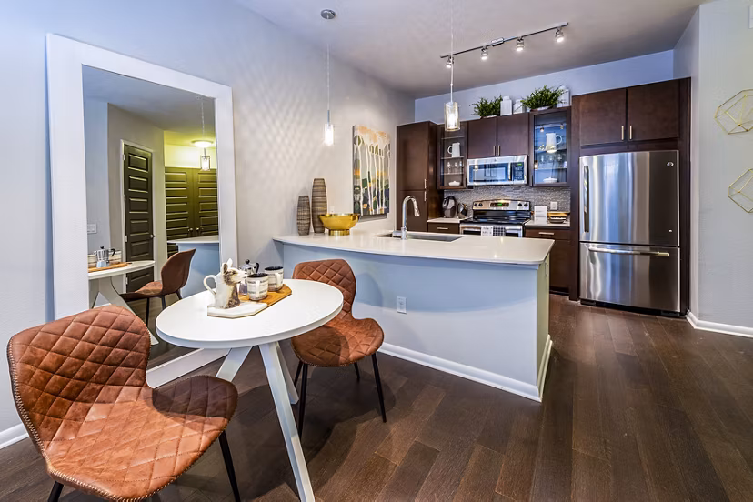 Dining area with elegant furnishings and chic lighting in Elan Memorial Park Apartments