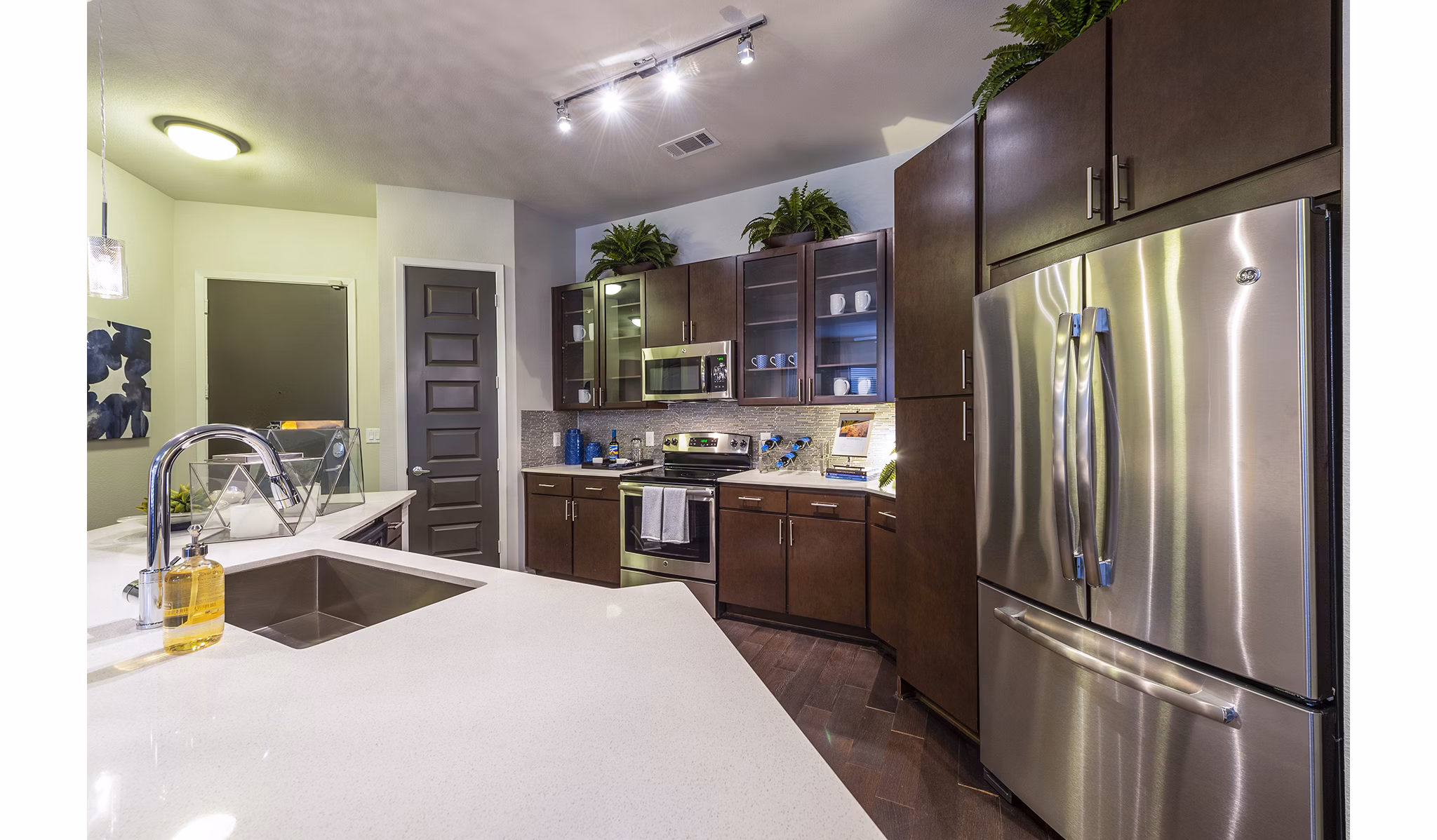 Modern kitchen with sleek countertops and stainless steel appliances at Elan Memorial Park Apartments