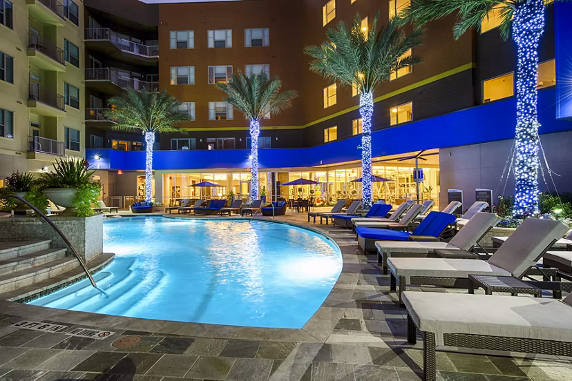 Luxurious outdoor pool at Elan Memorial Park Apartments offering a relaxing retreat with sun loungers and landscaped surroundings
