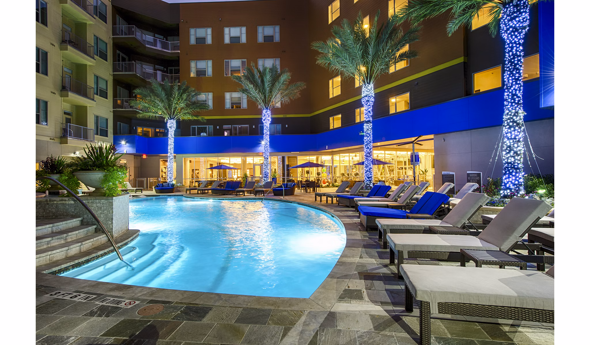 Luxurious outdoor pool at Elan Memorial Park Apartments offering a relaxing retreat with sun loungers and landscaped surroundings