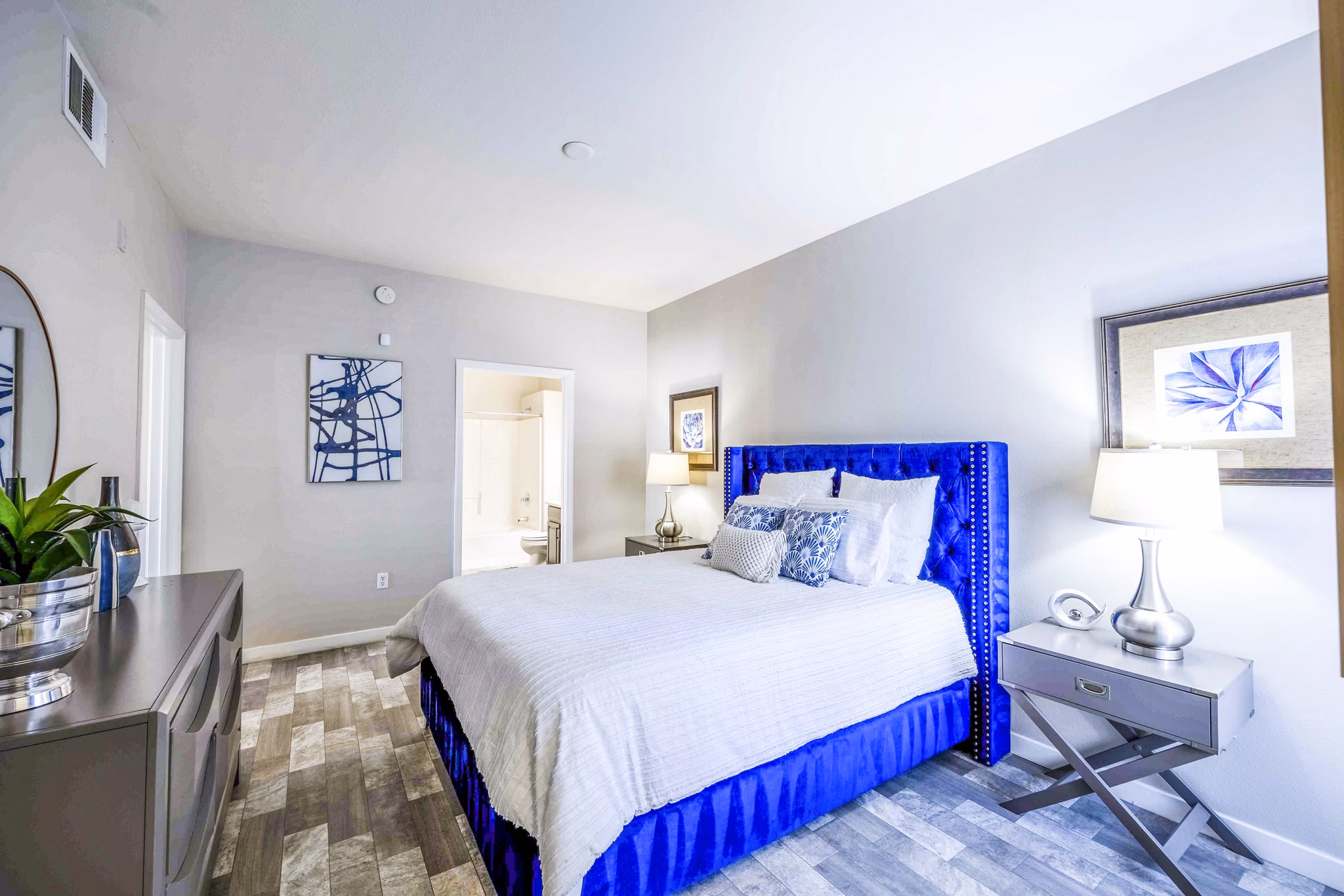 Cozy bedroom with stylish decor and large windows at Tesoro Ranch Apartments