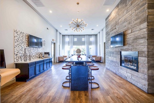 Clubhouse lobby featuring modern seating and artwork at Tesoro Ranch Apartments