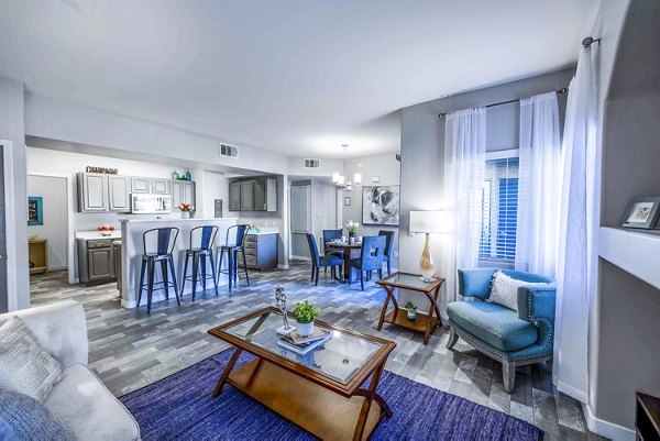 Open-plan living room with modern decor and natural light at Tesoro Ranch Apartments
