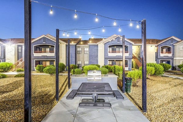 Outdoor grill area with modern seating at Tesoro Ranch Apartments, ideal for social gatherings and dining