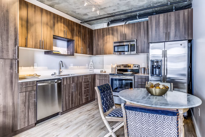 Dining room featuring modern kitchen appliances at Sequel Apartments