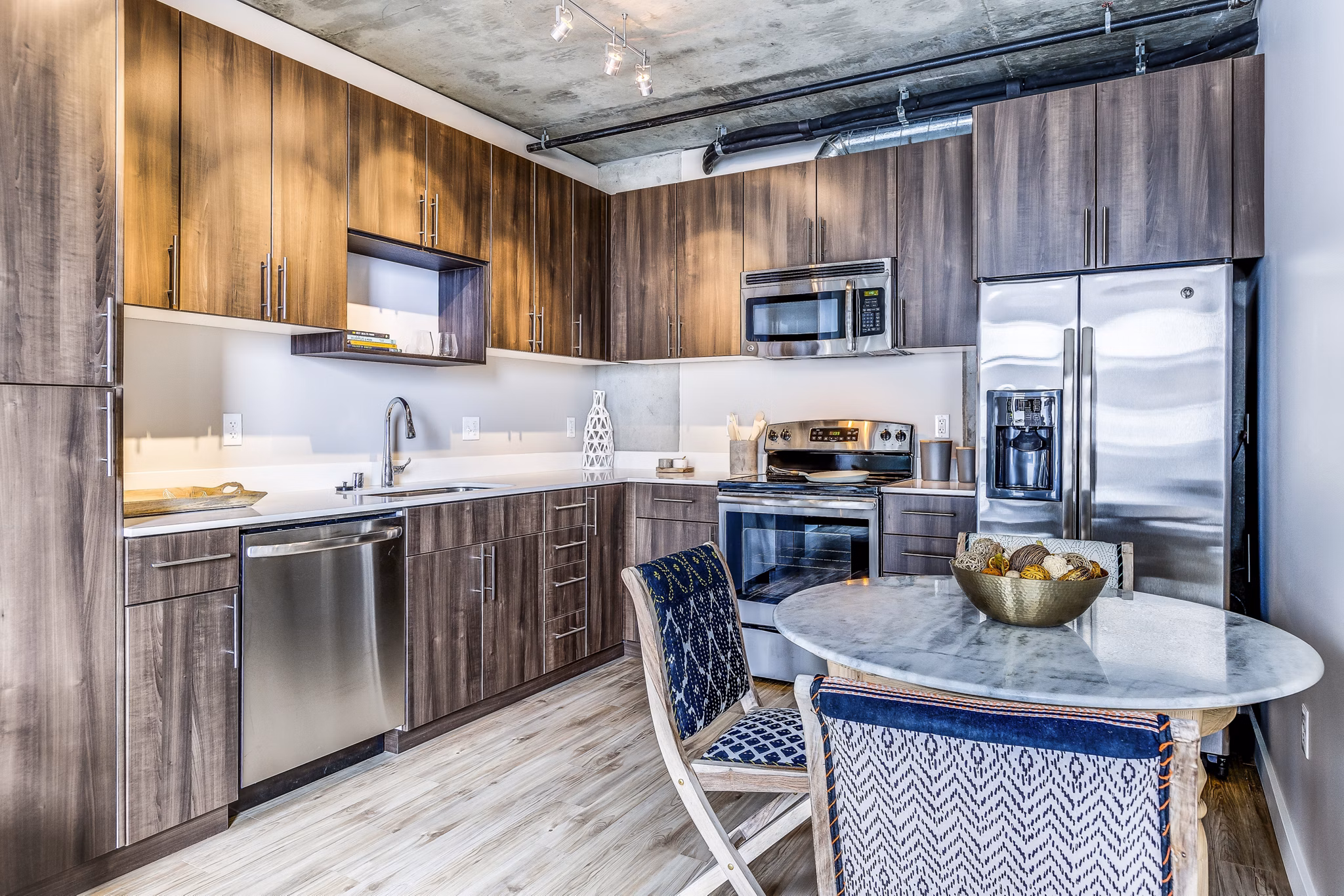 Dining room featuring modern kitchen appliances at Sequel Apartments