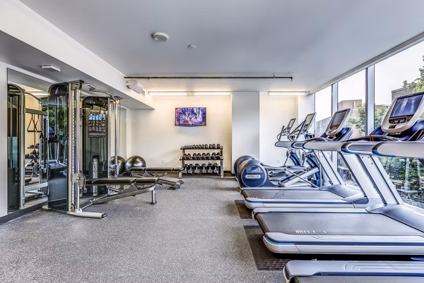 Modern fitness center with state-of-the-art equipment at Sequel Apartments