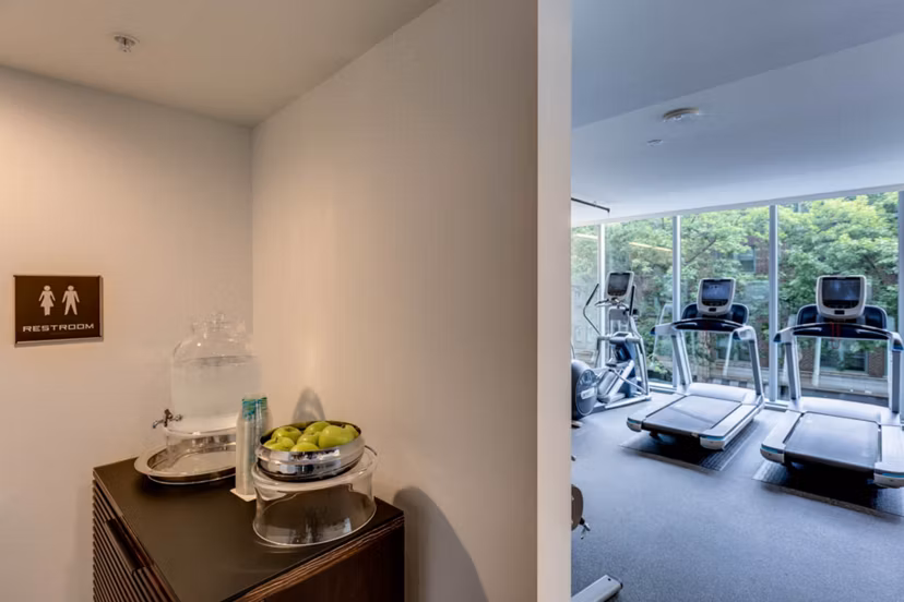Fully-equipped fitness room with modern machines at Sequel Apartments