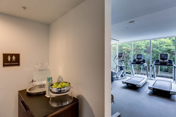 Fully-equipped fitness room with modern machines at Sequel Apartments