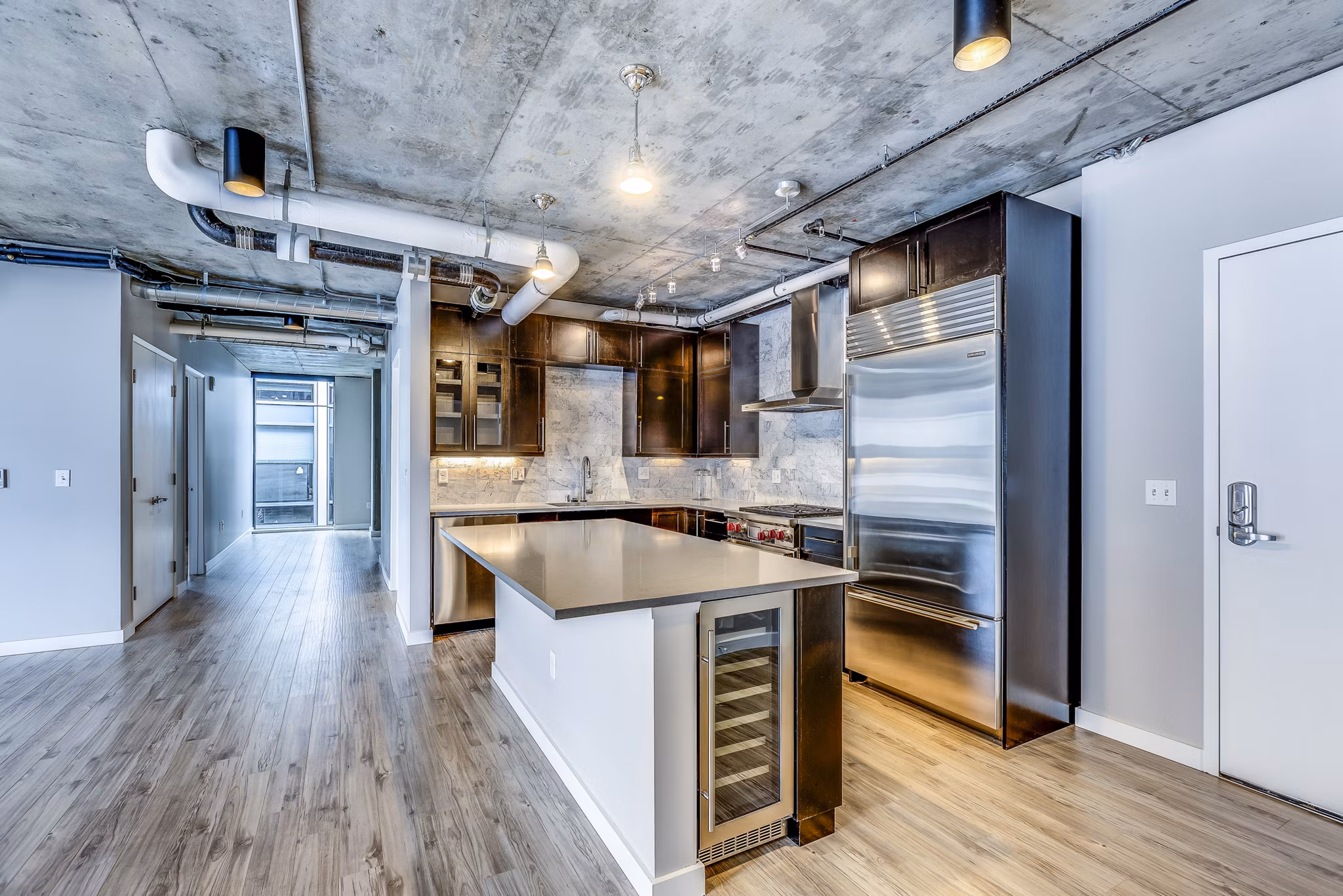 Modern kitchen with stainless steel appliances at Sequel Apartments, a luxury community