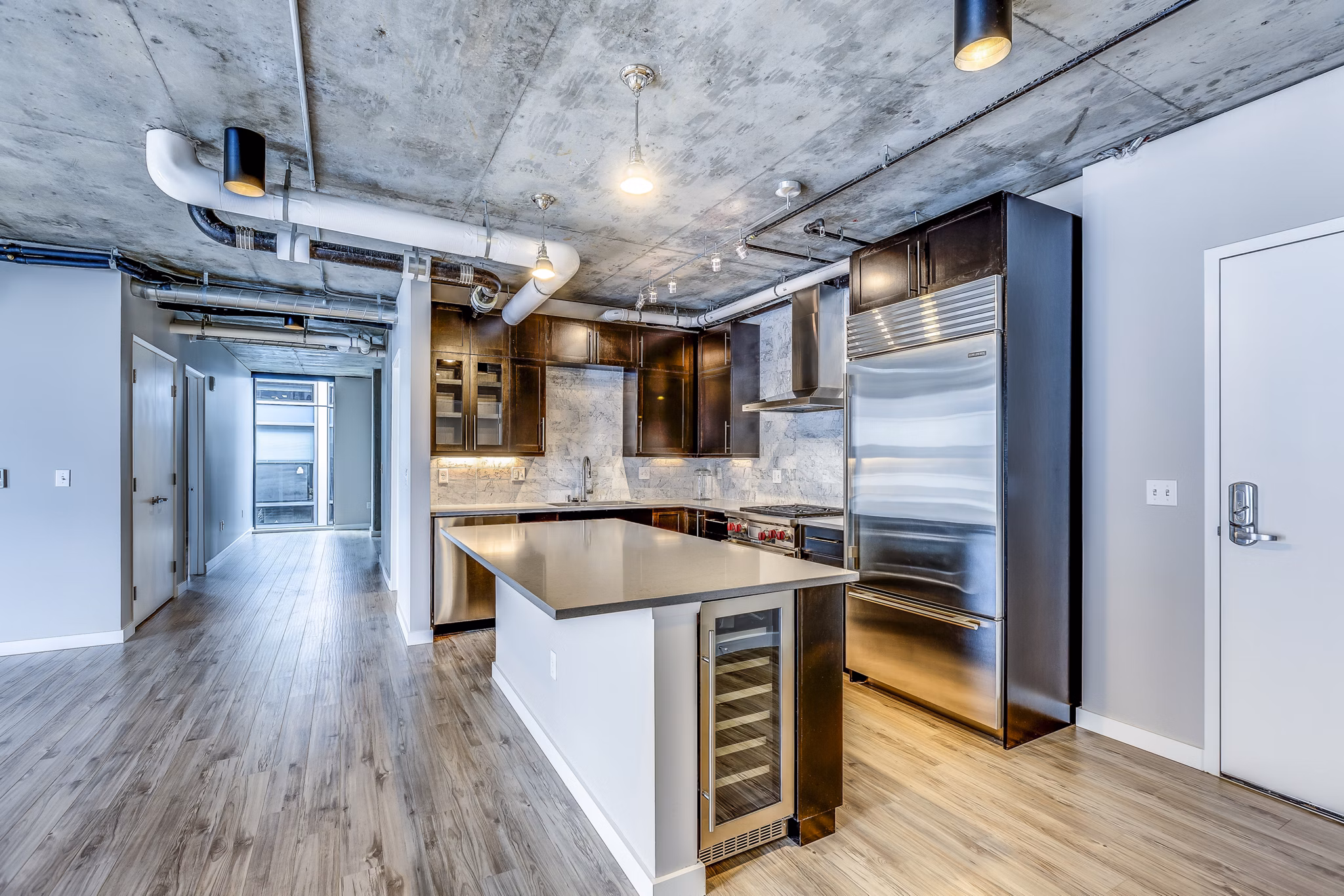 Modern kitchen with stainless steel appliances at Sequel Apartments, a luxury community