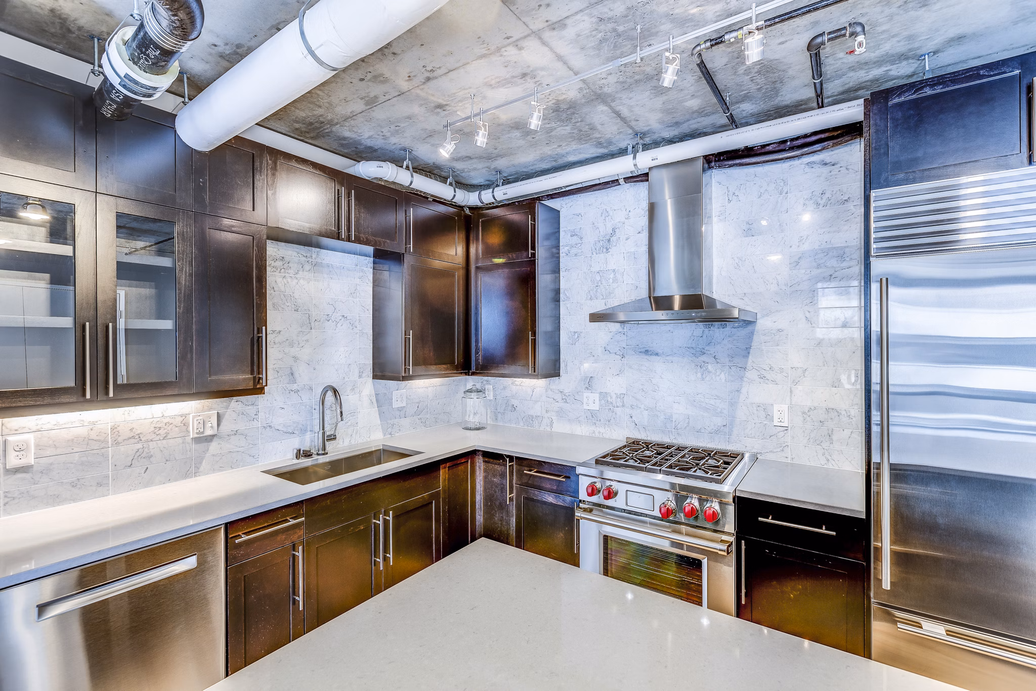 Kitchens featuring stainless steel appliances and granite countertops in Sequel Apartments