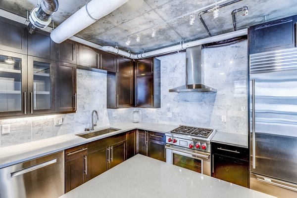 Kitchens featuring stainless steel appliances and granite countertops in Sequel Apartments
