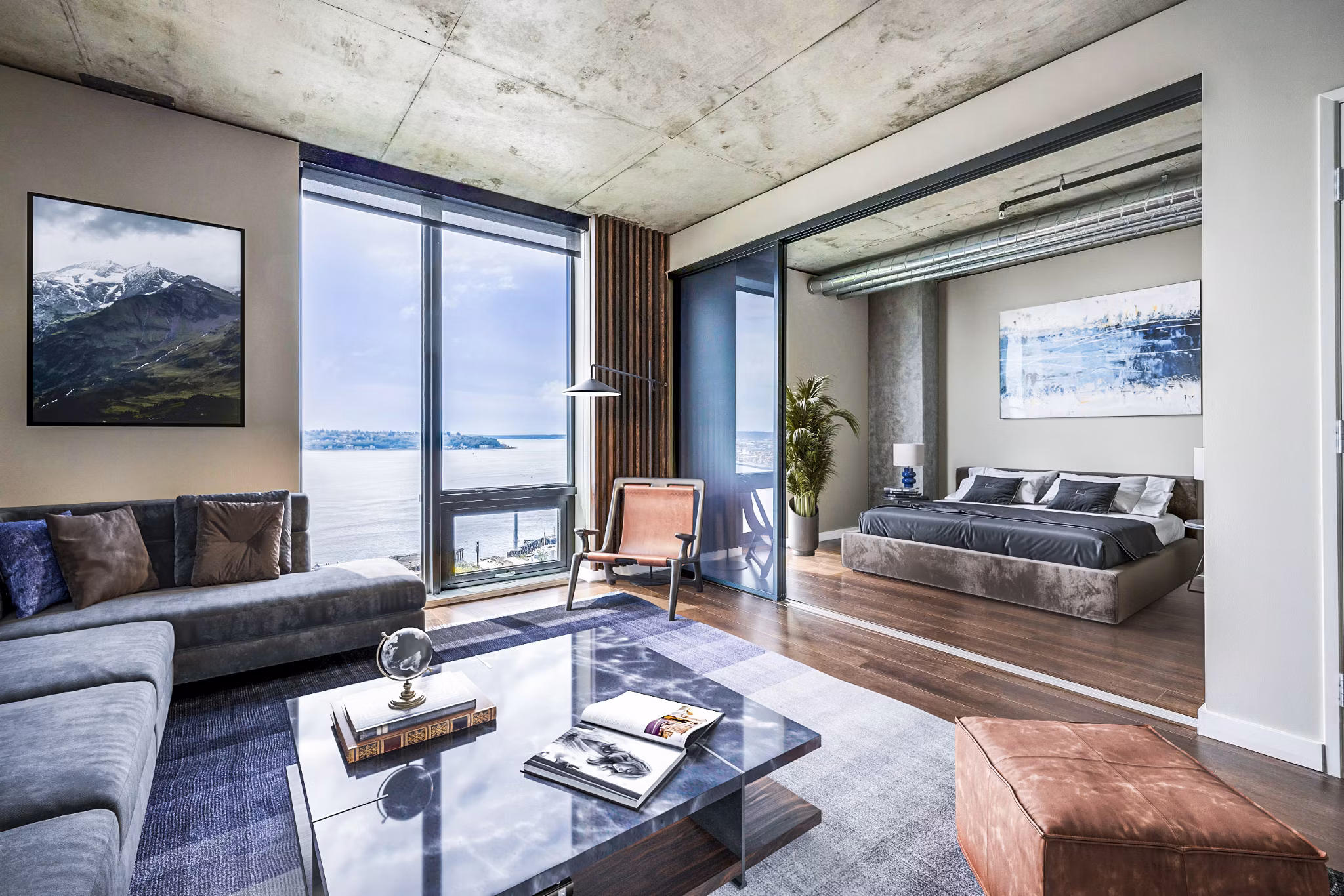 Cozy living room featuring modern decor and large windows at Sequel Apartments
