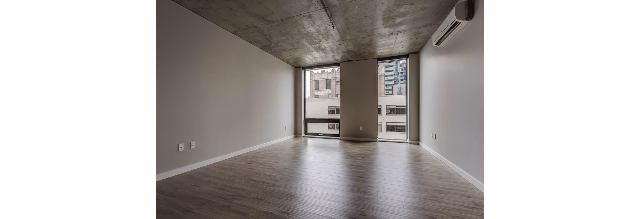 Open-concept living room with modern furnishings at Sequel Apartments, featuring sleek design and natural light