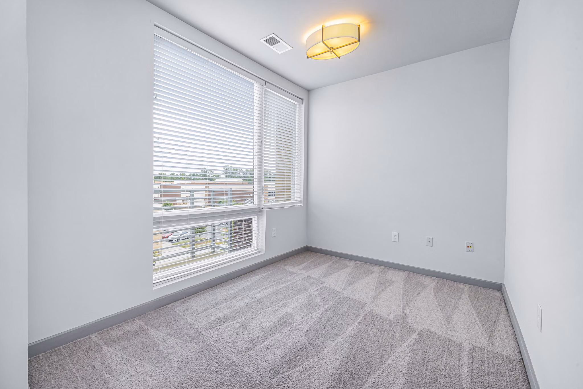 Cozy bedroom featuring modern furnishings at District Lofts Apartments, a Greystar luxury apartment community