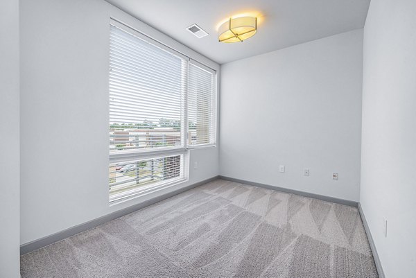 Cozy bedroom featuring modern furnishings at District Lofts Apartments, a Greystar luxury apartment community