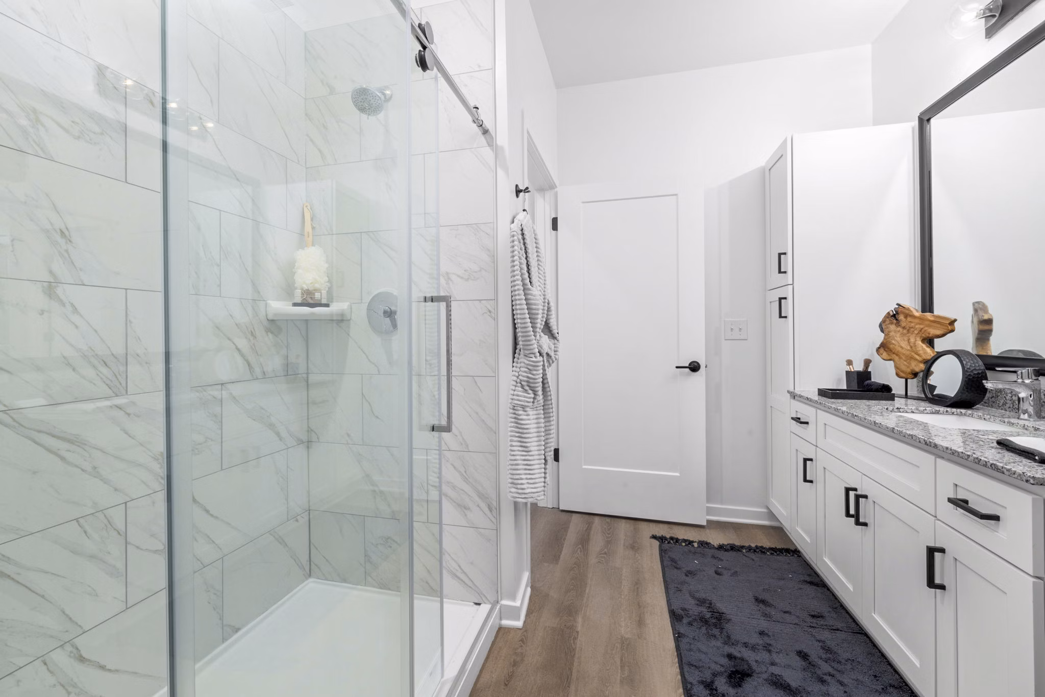 Modern bathroom with marble countertops at District Lofts Apartments