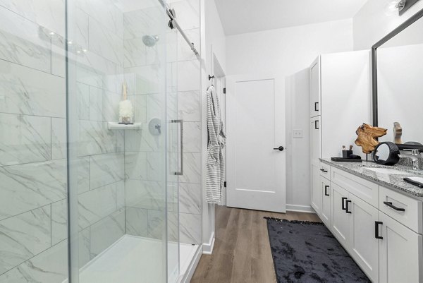Modern bathroom with marble countertops at District Lofts Apartments