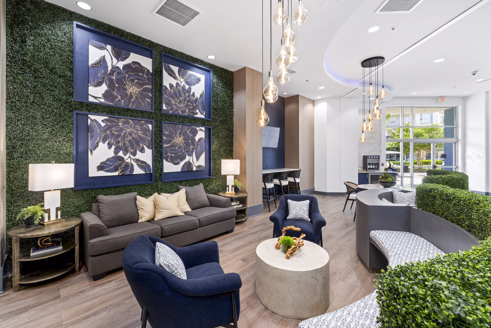 Modern clubhouse at District Lofts Apartments featuring a cozy lounge and community kitchen