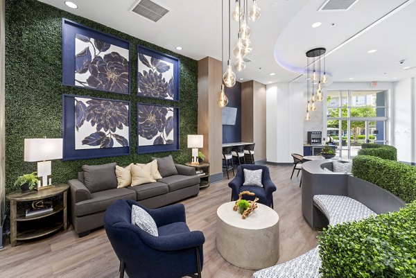 Modern clubhouse at District Lofts Apartments featuring a cozy lounge and community kitchen