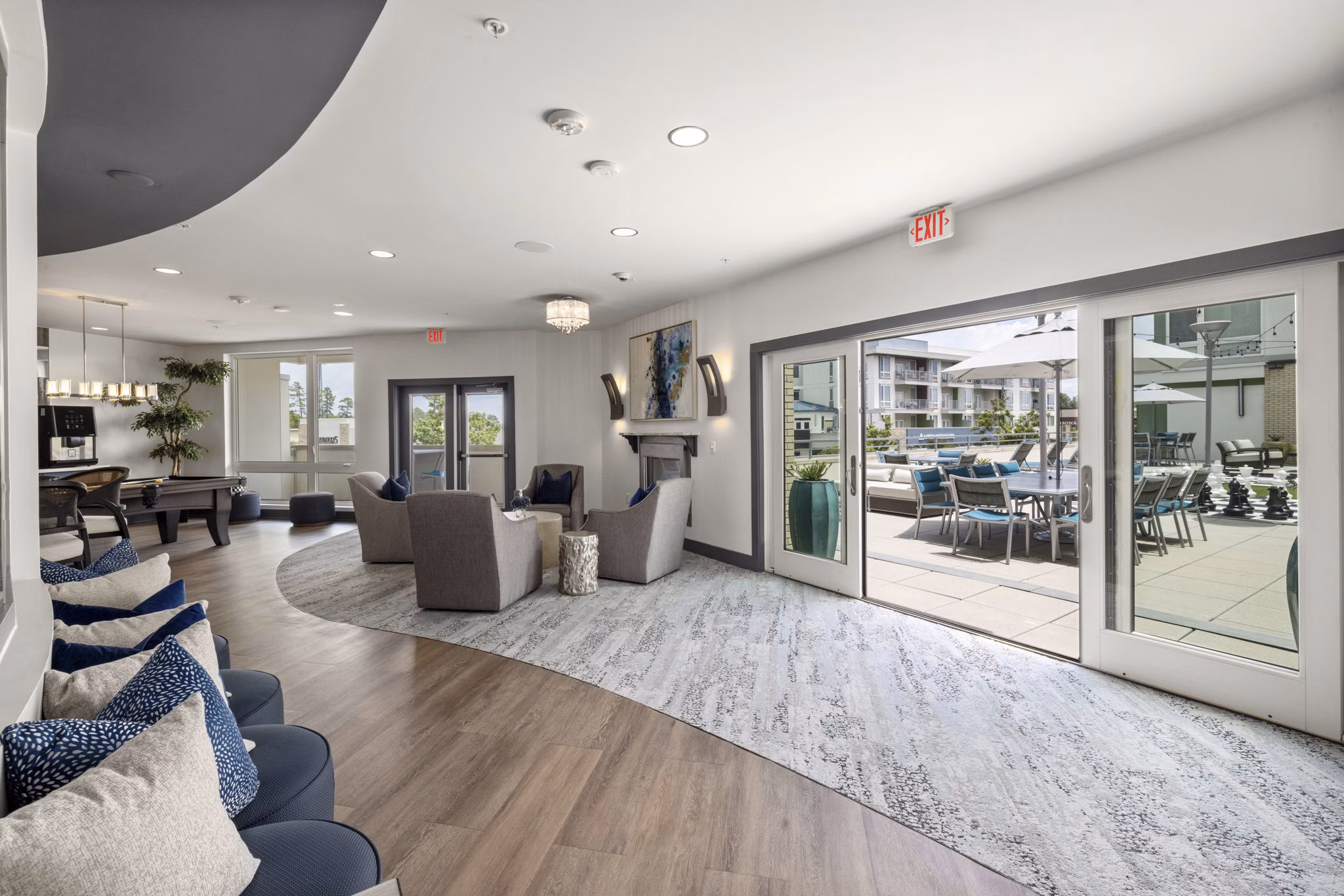 District Lofts Apartments: Stylish clubhouse featuring modern decor and ample seating, perfect for social gatherings