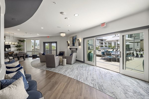 District Lofts Apartments: Stylish clubhouse featuring modern decor and ample seating, perfect for social gatherings