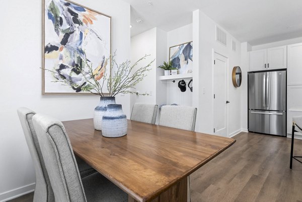 Dining room with modern furniture and pendant lighting in District Lofts Apartments